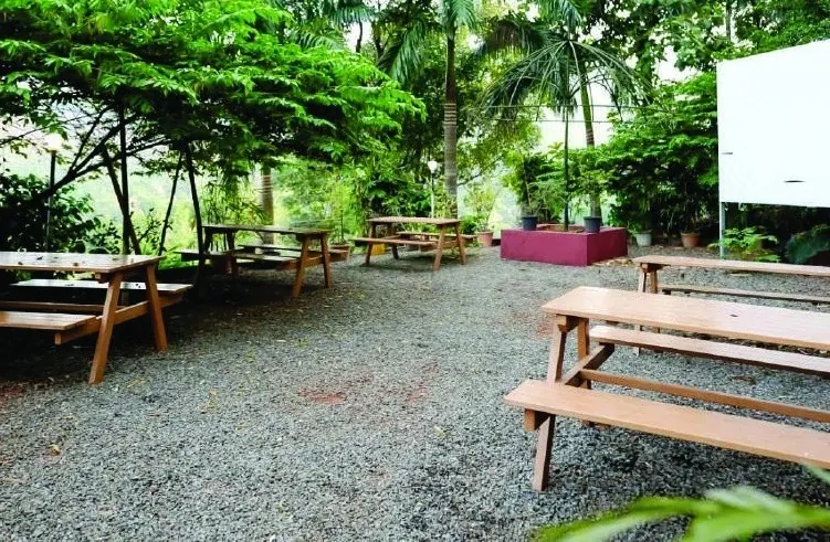 Open-air kitchen and dining area with picnic tables