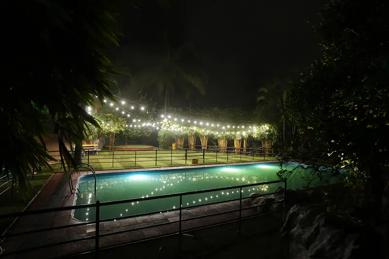 Wide view of the illuminated swimming pool at night