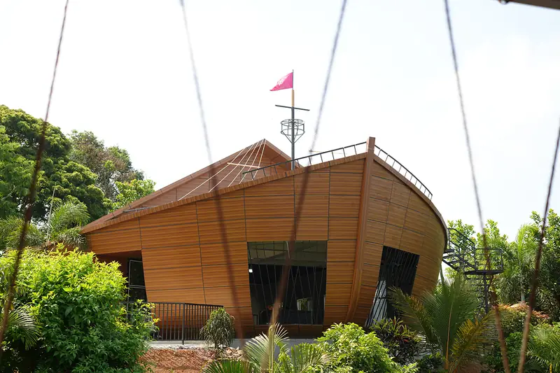 Ship-shaped auditorium at Purayil Resort Kakkadampoyil in daylight